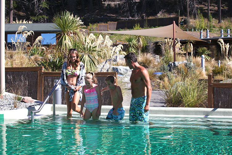 Family entering hot pools
