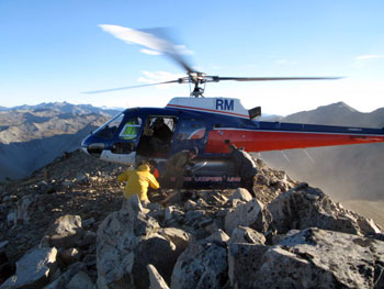 A helicopter drops off the construction team at the summit